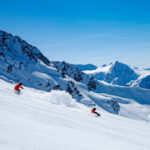A sit skier and their coach carve the corduroy on Whistler Blackcomb.